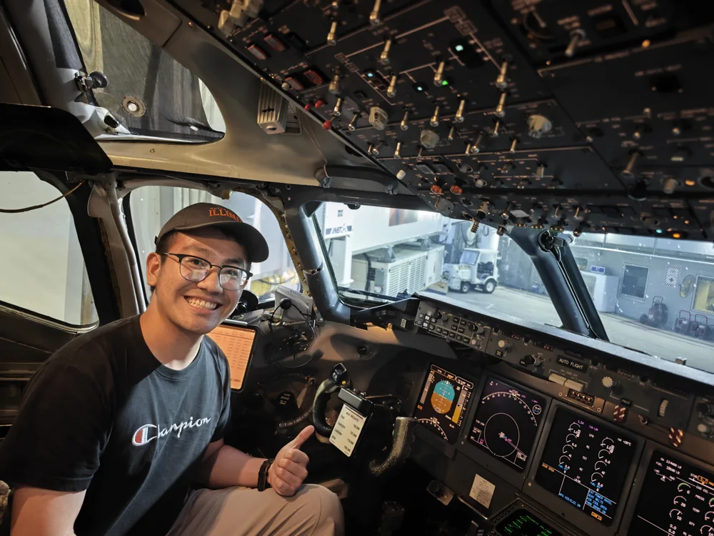 Ethan seated inside an aircraft flight deck.