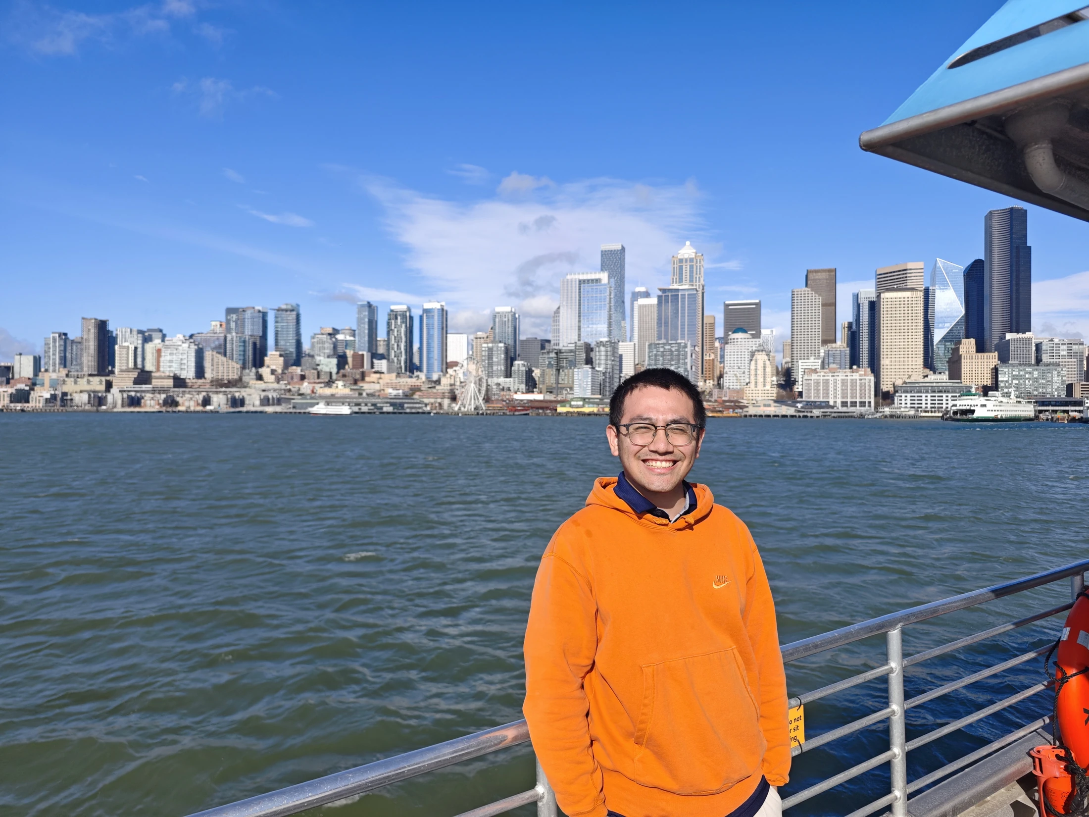 Ethan Chen in Seattle, with the waterfront skyline behind him